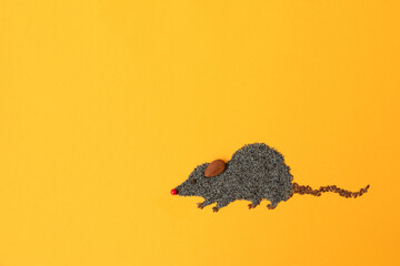 Obraz premium Cute mouse made of flax and poppy seeds on yellow background. Food art creative concept
