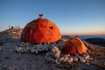Pelino bivouac and tent on the top of Monte Amaro at sunrise. Trekking in the Majella national...