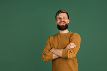 Caucasian man's portrait isolated over green studio background with copyspace