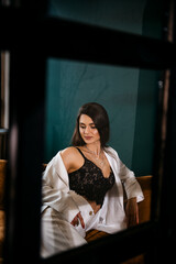 Fototapeta premium Fashion portrait of pretty sexy young brunette woman in white pantsuit