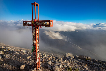 cross on the top of the mountain, trekking on Monte Amaro in the Majella national park, mountain range of the Apennines. Maiella mountain massif, Abruzzo, L'Aquila.