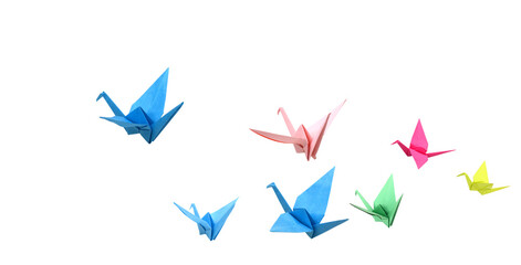 Colorful origami cranes flying on white