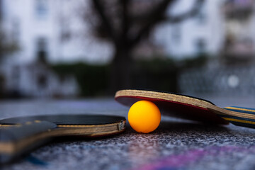 Table tennis bats and a ball with a purple heart sign on the table
