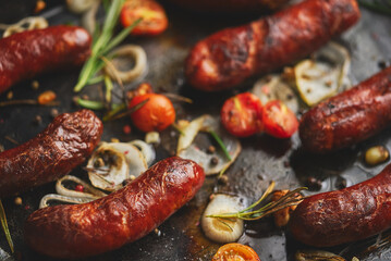 Delicious grilled sausages served on metal rusty tray. With barbecued vegetables