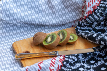  kiwi halves on a cutting board on a table close-up. background with kiwi fruit close-up.
