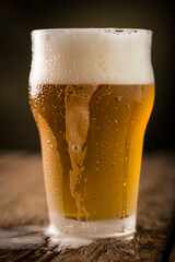 Glass of beer. Cold glass filled with beer.