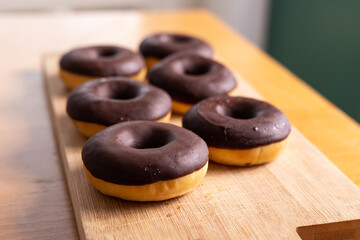 Chocolate donuts on a wood background