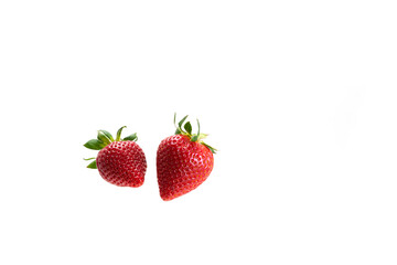 Two berries of juicy ripe strawberries on a white background