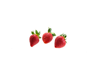 Three appetizing big berries of juicy ripe strawberries on a white background
