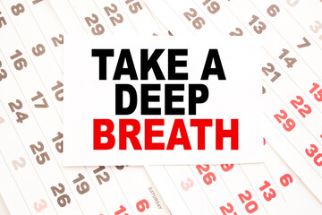 text TAKE A DEEP BREATH on a sheet from Notepad.a digital background. business concept . business and Finance.