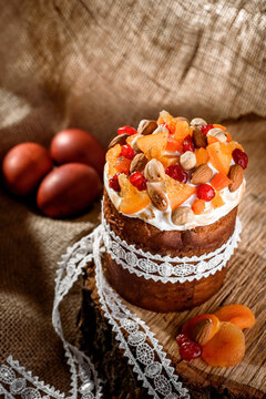 Easter cakes. Panettone. Traditional Easter cake with orange, candied fruit, raisins and cinnamon on a rustic background.