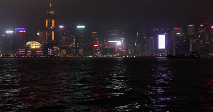 Victoria Harbour Skyscraper Buildings Lights Illumination at Night Pan in Hong Kong China
