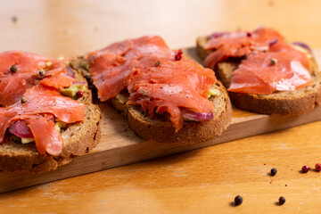 Salmon toast with avocado and red onions