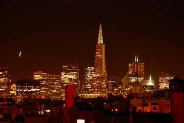 San Francisco skyline at night with an orange glow of lights. 
