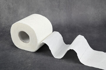 Roll of toilet paper. The unwound end in waves lies on a horizontal surface