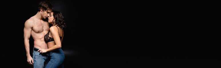 sexy woman and shirtless man hugging on black, banner.