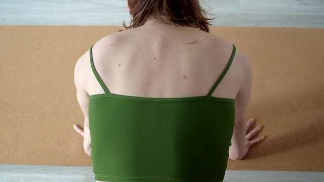 Slow motion high angle view on woman in green top doing scapular push up