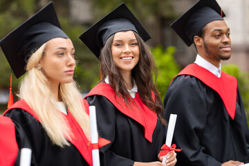 Attractive brunette lady standing among multiracial group of students