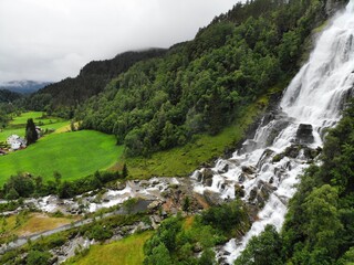 Fototapeta na wymiar Beautiful waterfall in Norway. Tvindefossen waterfall in Skulestadmo, Norway. Drone aerial view.