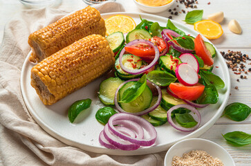 Salad with fresh and corn close-up on a light background.
