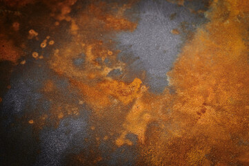 rusty metal surface with red, black and orange tones - worn steampunk background with scratches. Space for text
