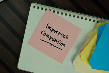 Imperfect Competition write on sticky notes isolated on Wooden Table.