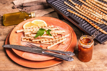 Grilled scorzonera with sauce on old wooden table