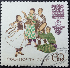 Fototapeta na wymiar Postage stamp of 'Uzbek folk costumes' printed in Republic of USSR. Series 'Costumes of the peoples of the USSR' by artist V. Pimenov, 1960