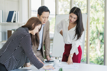 Fototapeta premium Team, Group of asian young businessman, businesswoman people working marketing plan, discussing on paperwork with teamwork, colleagues at office, workplace. Brainstorm, discuss business concept.