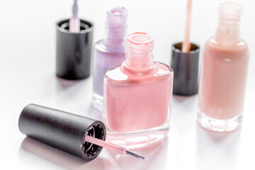 collection of nail polish on white desk background