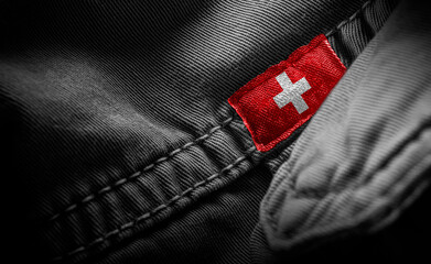 Tag on dark clothing in the form of the flag of the Switzerland