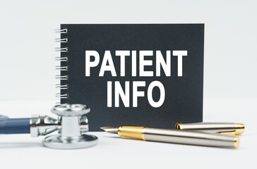 On a white background lies a stethoscope, a pen and a black notebook with the inscription - PATIENT INFO