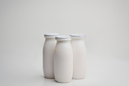Bottles of liquid yogurt isolated on a white background.Concept - dairy products contain probiotic bacteria. Dietary supplements in bottles. Vitamins Sale of probiotics. 