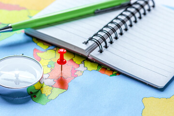 booking travel concept with notebook on map background