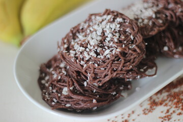 String hoppers made from finger millet flour. Topped with grated coconut. An experimental version of a popular rice dish from Kerala called Idiyappam