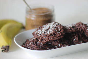 String hoppers made from finger millet flour. Topped with grated coconut. An experimental version of a popular rice dish from Kerala called Idiyappam