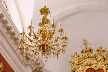 A huge golden chandelier with electric candles.