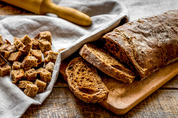 Dried crumbs with bread on kitchen table background