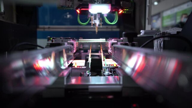 Automatic machine for diagnostics of electronic boards, production. Small needles are checking the electronic circuit. Creation of electronic boards and microcircuits. Processor manufacturing.