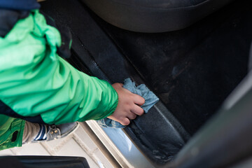 cleaning car interior rag in a child's hand