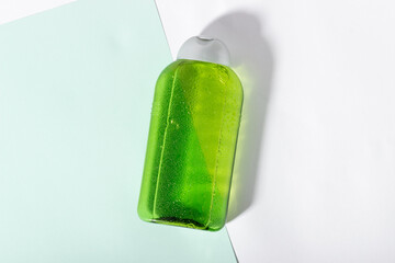 Facial cleanser bottle. Lotion or micellar water for face cleansing. Liquid cosmetic product in green packaging. Natural cosmetics concept