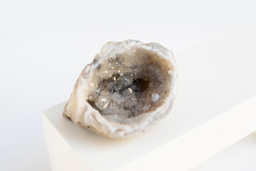Druse of natural mineral agate. Closeup photo. Beige crystal with black small inclusions.
