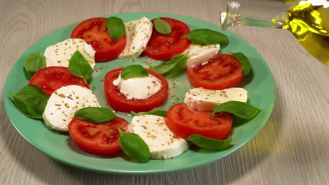 Italian caprese salad. juicy fresh tomatoes, creamy mozzarella, fresh basil, and extra virgin olive oil.Healthy food.Healthy diet.bio food,organic food.healthy lifestyle concept.Italy