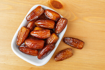 Date palm fruits on wooden background