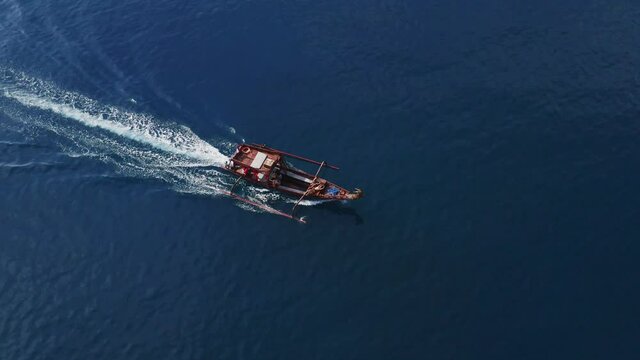 Aerial view around a Asian fishing boat on the ocean - circling, drone shot