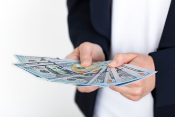 Business woman holding 100 dollars in hand over white background. economy and business concept...