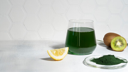 Composition with healthy green spirulina chlorella drink in the glass with green algae seaweed...