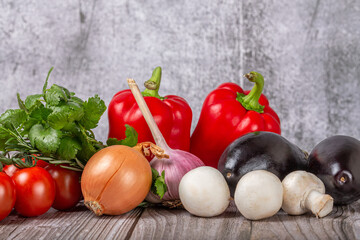 bright group of ripe vegetables om dark wood table