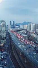 Residential buildings and mountains with traffic view.