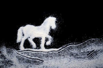 Drawing of a horse, white sand on a black background